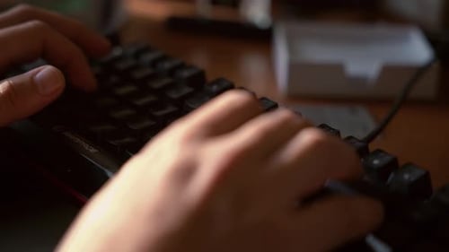a guy using mechanical keyboard for writing
