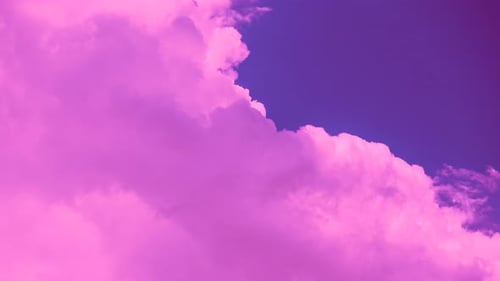 Abstract Puffy Pink Clouds Flowing in Blue Sky