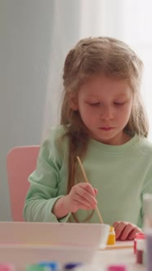 Serious Little Girl Draws Ebru Art with Sister at Workshop