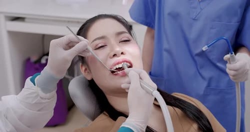 Woman Receives Dental Checkup in Modern Dentist Office
