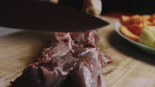 Woman Cutting Beef Meat with Knife