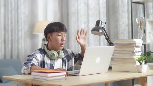 Teen Student Video Conferencing at Home with Laptop