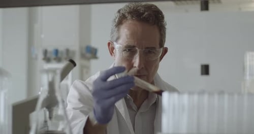 Scientist Examining Blood Sample in Test Tube