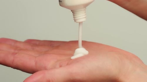 Cream Poured on Hand in Close Up