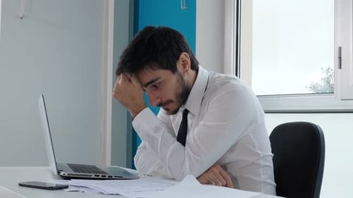 Young Man Works at Computer in Modern Office