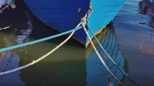 Ropes Tied To Wooden Fishing Boat In Harbor