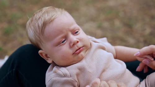 Smiling Baby Being Cared For by Family