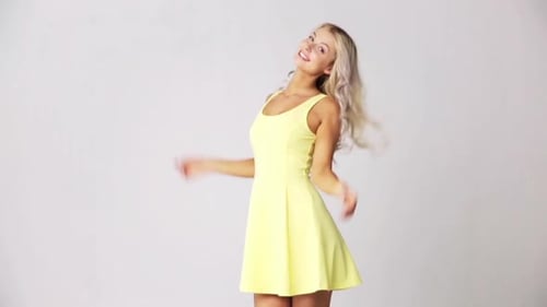 Happy Woman Smiling and Dancing in Studio