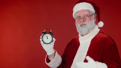 Santa Claus Holding an Alarm Clock on Red