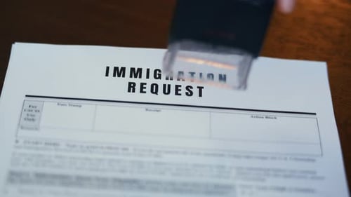 Close Up of Visa Application Form with Red Approved Stamp Immigration and Travel Authorization