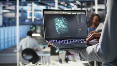 Close Up of Data Center Admin Using Machine Learning Algorithms on Laptop