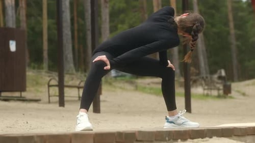 Woman Stretching Before Workout in Nature