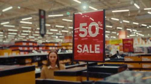 Shopping for Great Deals at a Store During a 50 Percent Discount Event in a Bustling Retail