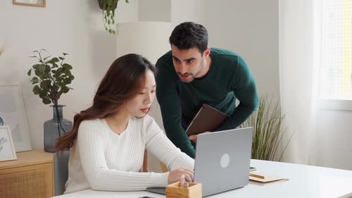 Young Adults Working Together at Home on Laptop