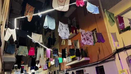 Linen Clothes Hang on Lines Between Houses in an Old District of Barcelona
