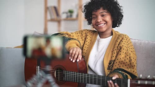 Young Adult Plays Guitar and Records Video