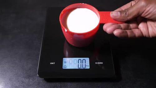Measuring cup placed on kitchen scale