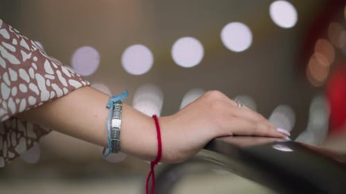 Woman's hand on escalator in shopping mall