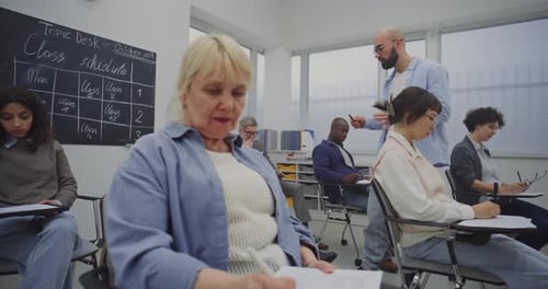 Classroom of Students Taking Notes During a Lecture