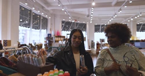 Women Friends Shopping Browsing Merchandise On Display In Craft Store Slow Motion