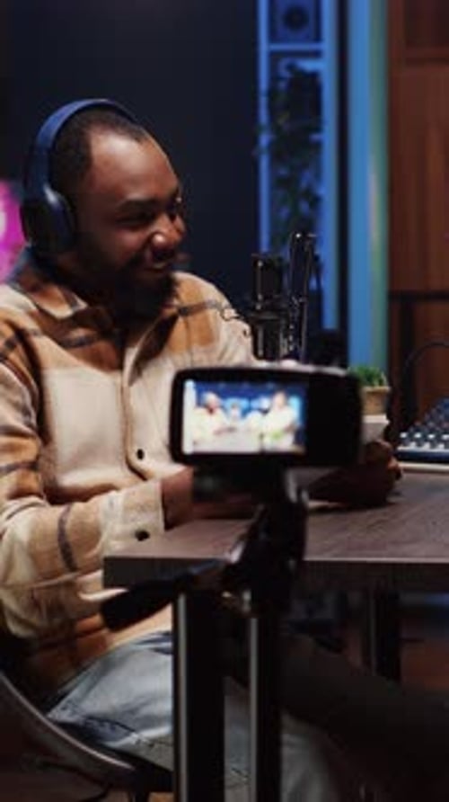 Man Records Podcast at Home Studio at Night