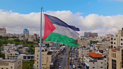 Aerial View of City with Waving National Flag