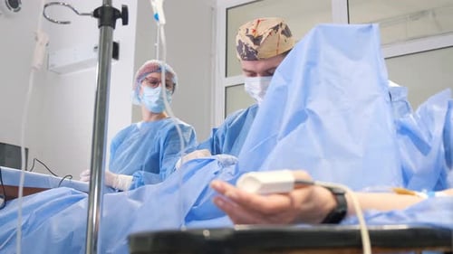 Medical Professionals Attending to Patient in Operating Room