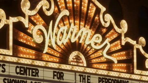 Close up of a classic theater sign lit up.