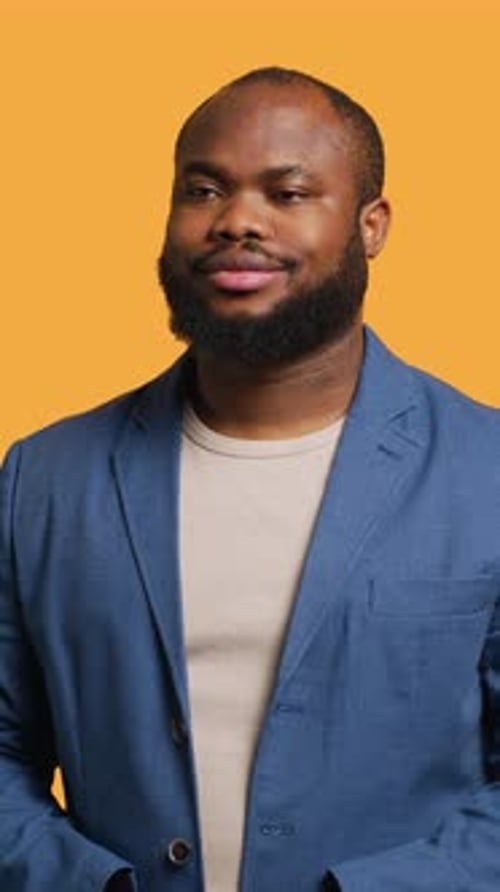 Vertical Video Portrait of Cheerful Man Smiling Looking Pleased Studio Background