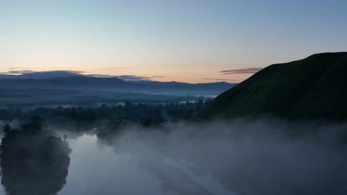 Low-lying lake fog at dawn - descending aerial reveal