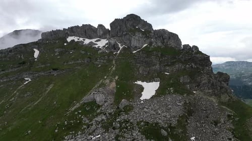 Epic rock in the clouds. Aerial view. Incredible mountain panorama. Mountains in the clouds.