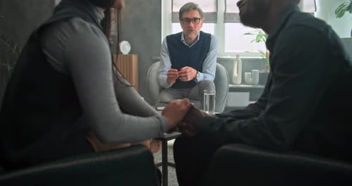 Couple Holding Hands During Therapy Session