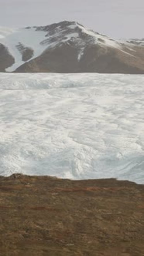 A Majestic Glacier Surrounded By Towering Mountains