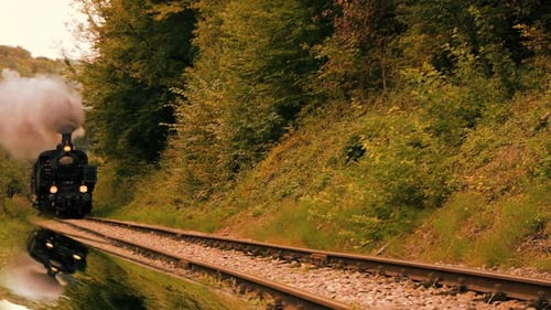 Historical Steam Engine Train Locomotive Driving on Railroad Tracks