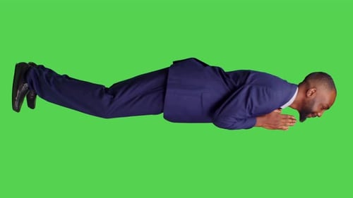 Man in Suit Floating Against Green Screen