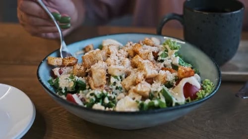Woman Eating Caesar Salad