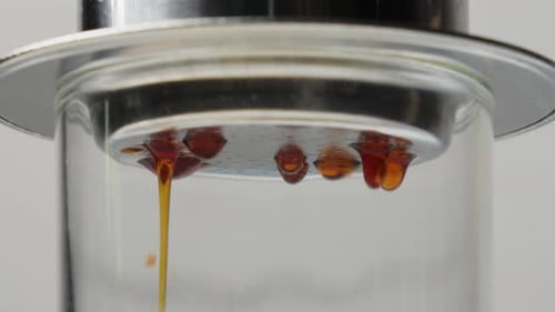 Close Up of Liquid Dripping Through Glass
