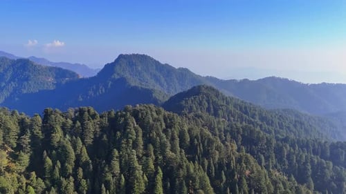view of misty hills and valleys stretching into the horizon under a soft