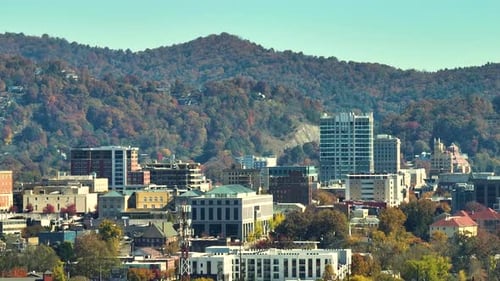 Asheville City in North Carolina with High Buildings and Mountain Hills in Distance