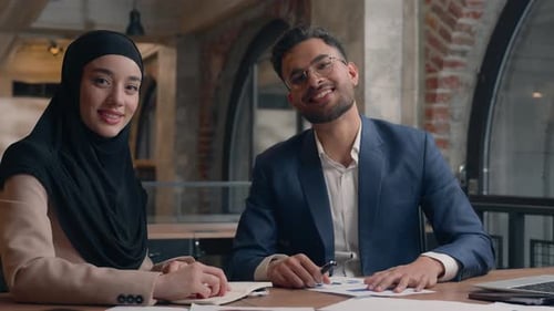 Two Business Partners Colleagues Happy Male Female Coworkers Writing at Office Arabian Indian Man