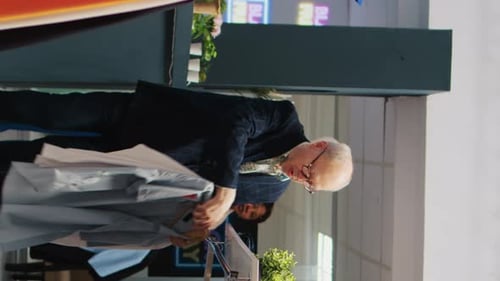 Employees Working at Clothing Store With Apparel