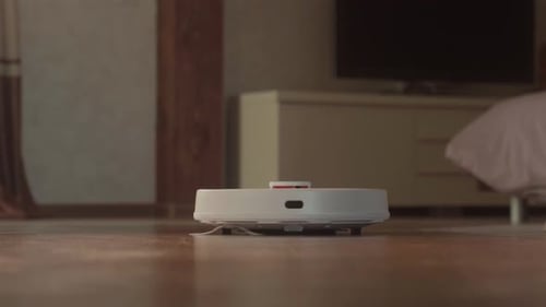Robotic Vacuum Cleaner Cleaning the Floor at Home