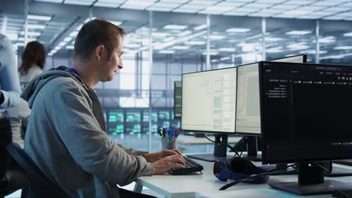 Man Operating in Server Hub Capable of Processing Vast Amounts of Data with Alternate Camera Angle