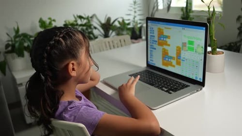 Hispanic Girl Student Coding a Video Game with a Laptop. STEAM, Mathematics Engineering Science Tech