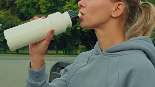 Caucasian Fit Woman Sportswoman Drink Fresh Cold Water Body Hydration After Morning Sport in City
