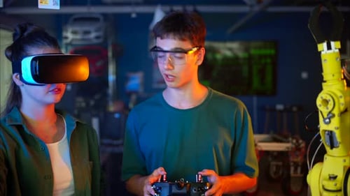 Man Controls Robot Arm with Remote in Lab