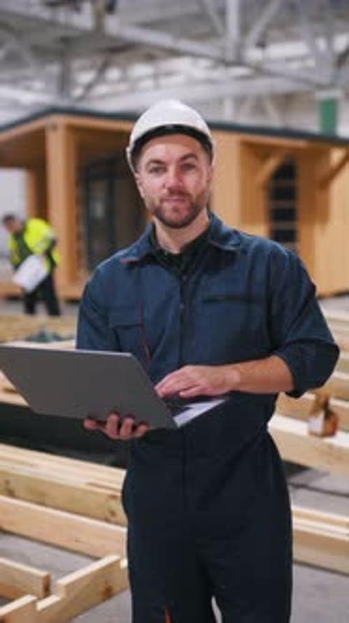 Male worker is in the modern warehouse or manufacturing company.