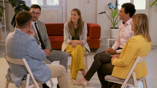 Group of business people having a meeting while sitting in circle in office.