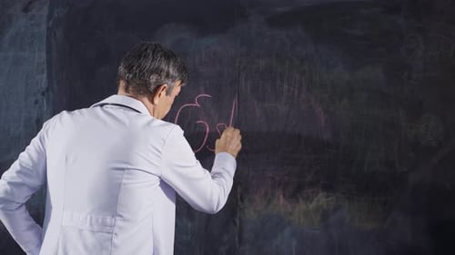 Male doctor writes Estrogen on the blackboard.
