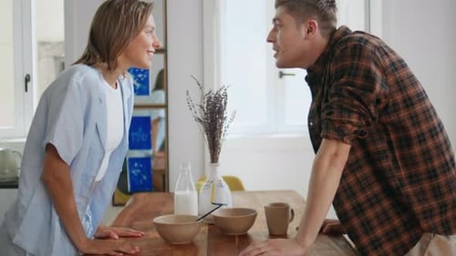 Affectionate Couple Sharing Cheerful Breakfast at Home